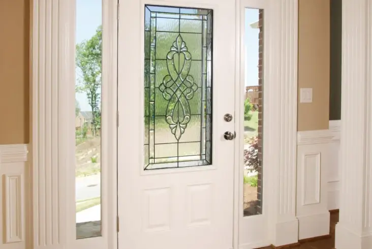 Professional front door replacement showing a white decorative entry door installed in a Northeast Ohio home.